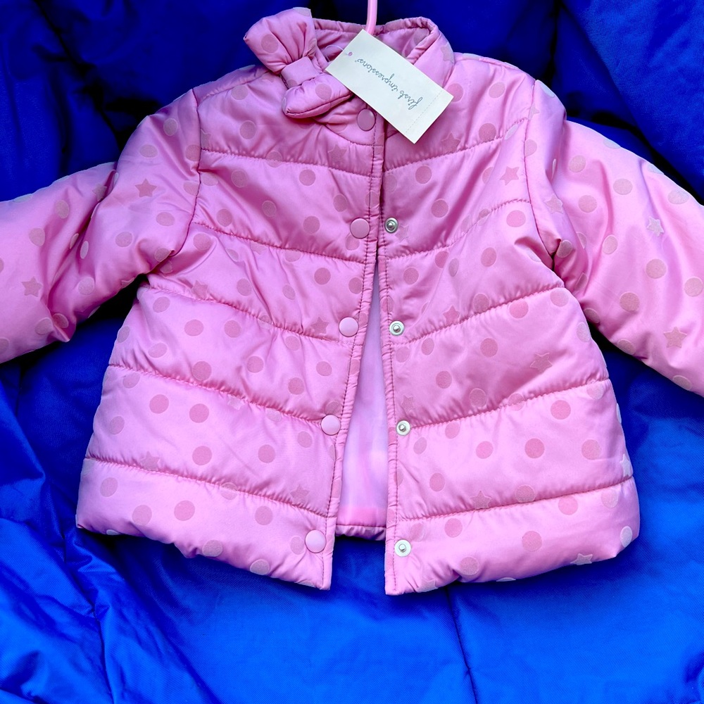 Cute little girls winter jacket with a bow and poka dots.